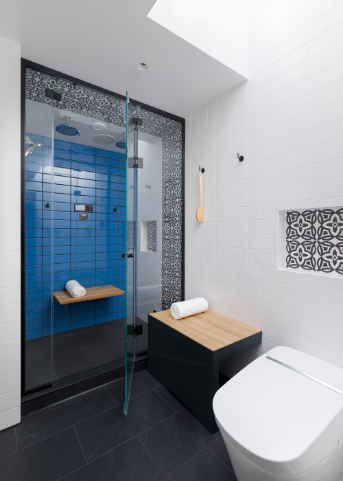 Classic Contrast: Black and White Bathroom with a Glossy Blue Shower