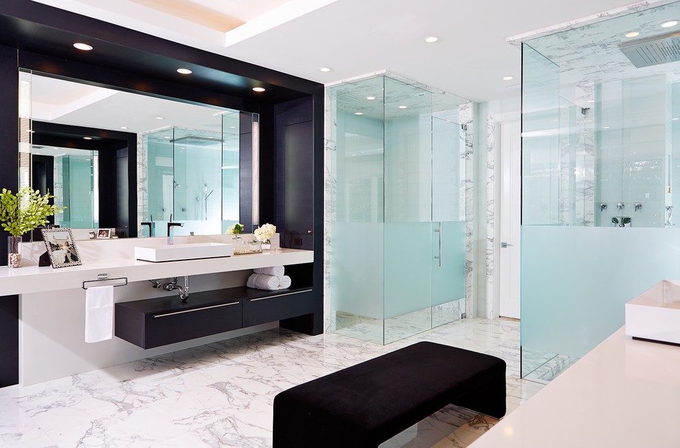 Design ideas for an expansive contemporary master bathroom in Tampa with a vessel sink, flat-panel cabinets, black cabinets, a corner shower, white tile, marble, white walls, marble floors, solid surface benchtops, white floor, a hinged shower door and white benchtops.