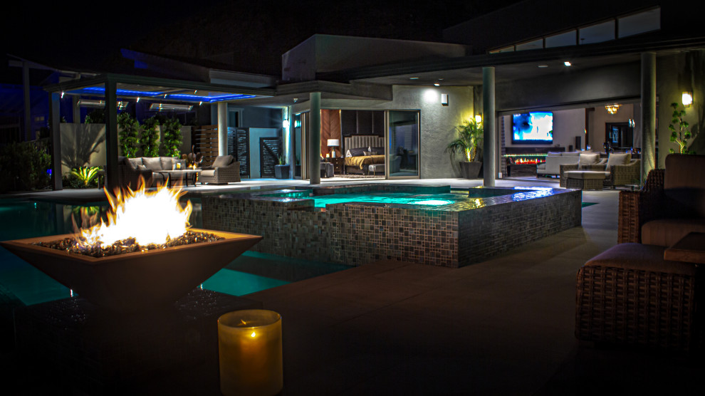 Design ideas for a large contemporary full sun backyard landscaping in Las Vegas with a fire pit and decking.