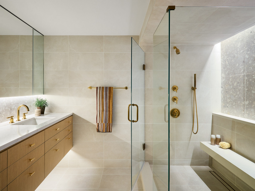 Example of a trendy beige tile beige floor corner shower design in Chicago with flat-panel cabinets, medium tone wood cabinets, an undermount sink, a hinged shower door, white countertops and a floating vanity