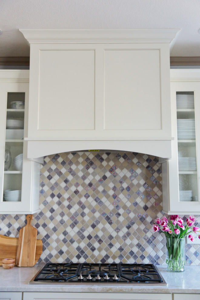 Eat-in kitchen - large transitional u-shaped light wood floor eat-in kitchen idea in Denver with a farmhouse sink, shaker cabinets, white cabinets, quartz countertops, multicolored backsplash, porcelain backsplash, stainless steel appliances and an island