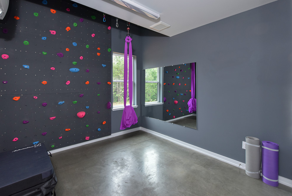 This is an example of a transitional home climbing wall in Other with grey walls, concrete floors and grey floor.