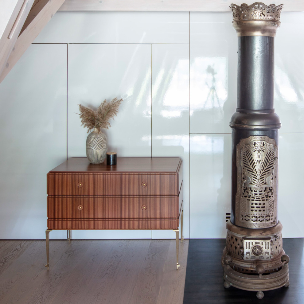 Design ideas for a scandinavian living room in Copenhagen with white walls, dark hardwood floors, a standard fireplace, a metal fireplace surround and beige floor.