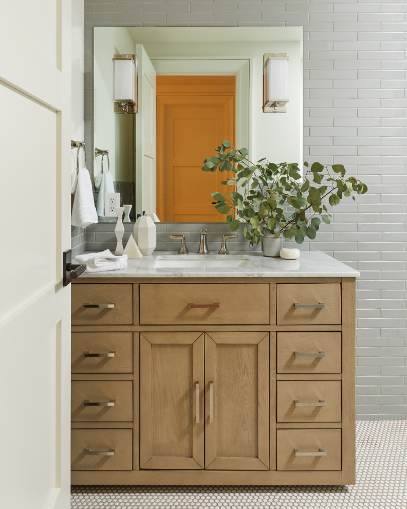 This is an example of a transitional bathroom in New York with shaker cabinets, gray tile, subway tile, grey walls, mosaic tile floors, an undermount sink, white floor, white benchtops, a single vanity and a built-in vanity.