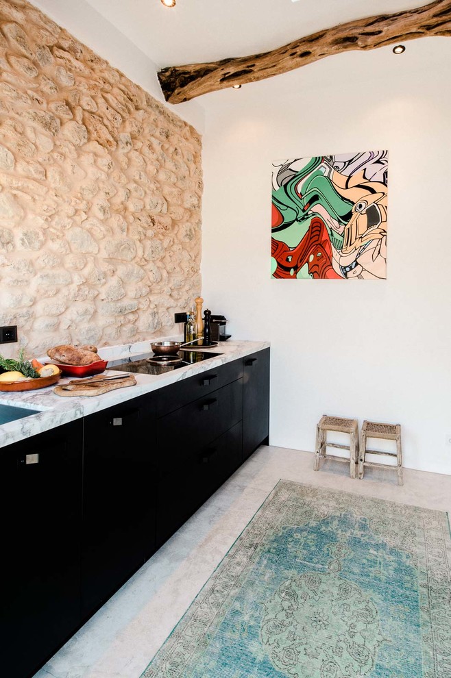 Photo of a small mediterranean single-wall open plan kitchen in Other with flat-panel cabinets, black cabinets, marble benchtops, beige splashback and no island.