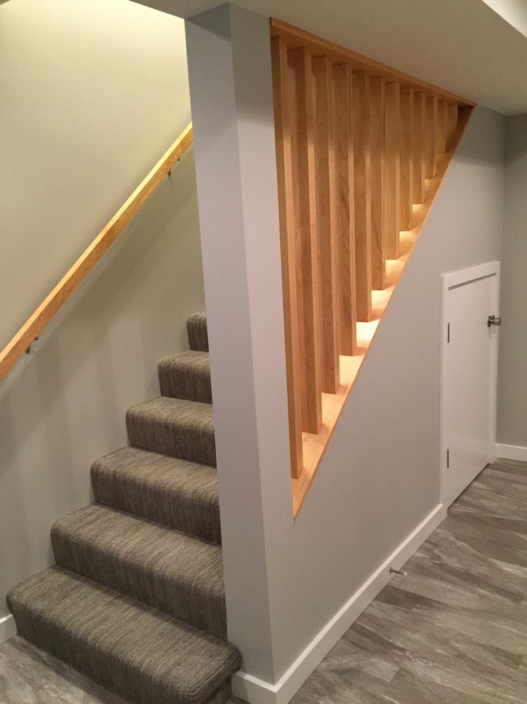 Inspiration for a mid-sized transitional carpeted staircase remodel in Seattle
