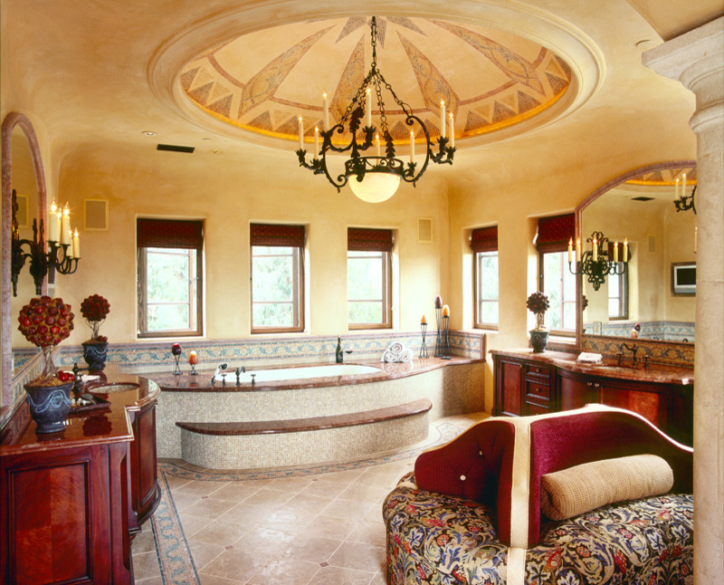 Large mediterranean master bathroom in Santa Barbara with furniture-like cabinets, dark wood cabinets, beige tile, stone tile and marble benchtops.