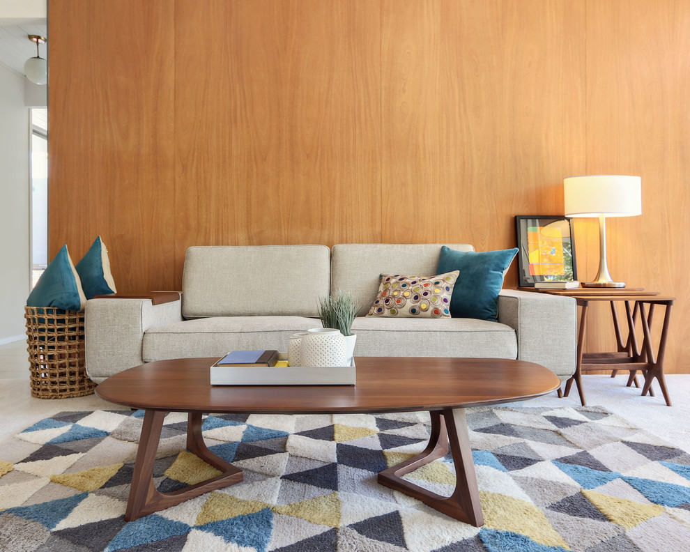 This is an example of a mid-sized midcentury open concept living room in San Francisco with brown walls, carpet, no tv and grey floor.