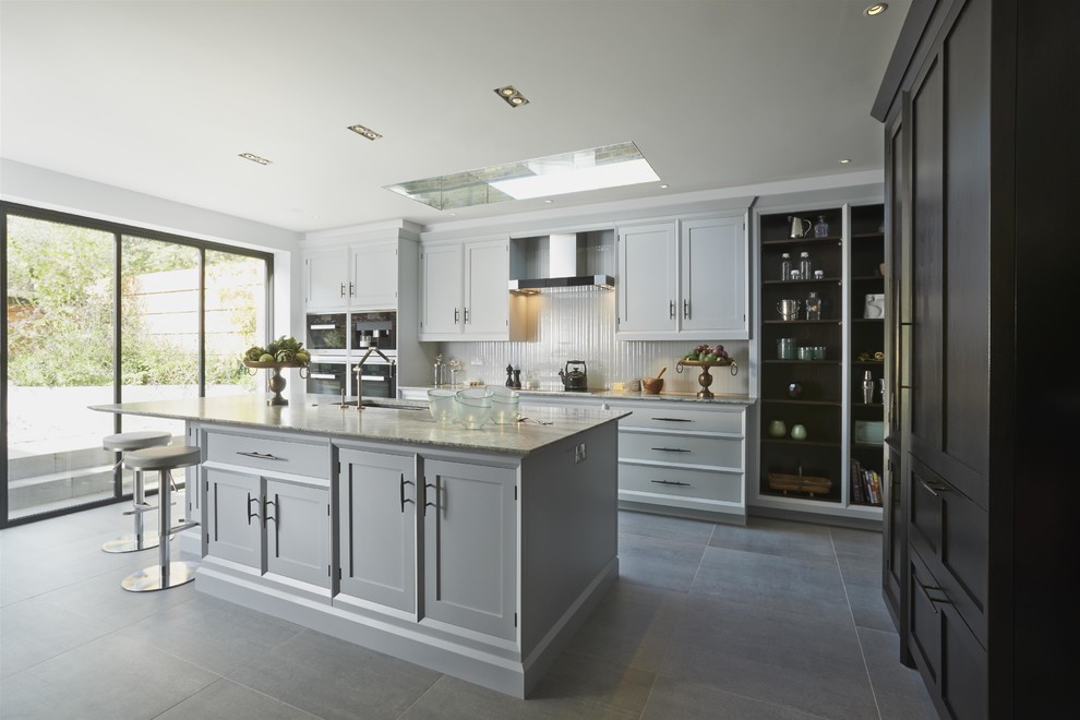 Transitional kitchen in London with with island.