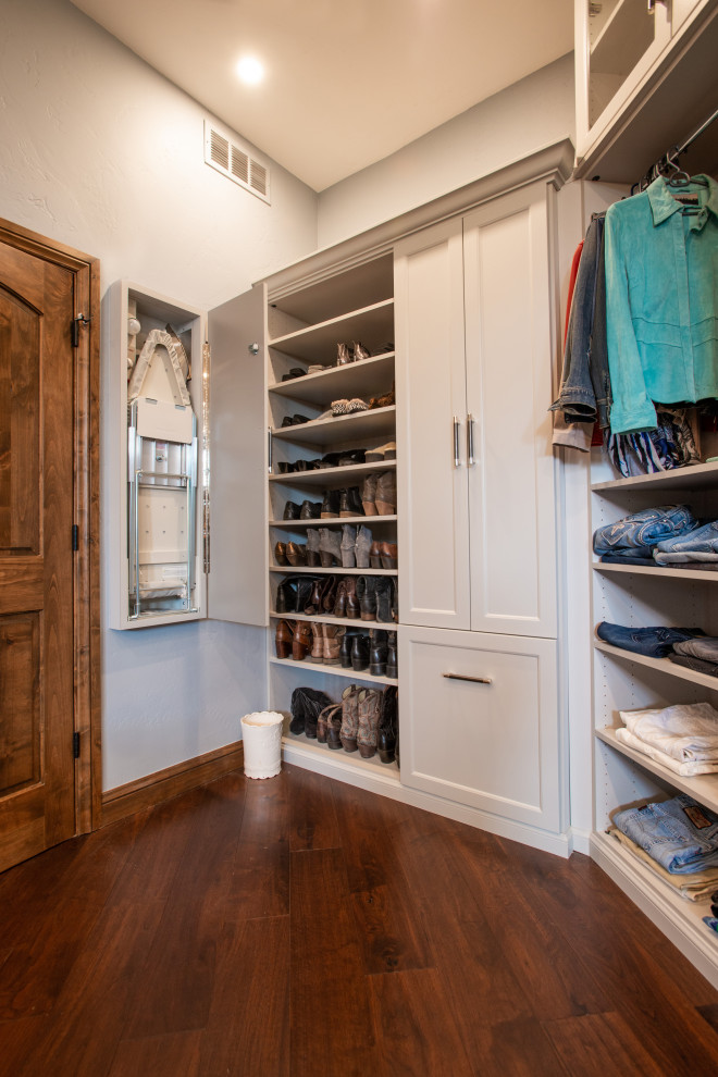 Large transitional gender-neutral dressing room in Denver with raised-panel cabinets, grey cabinets, dark hardwood floors, brown floor and vaulted.