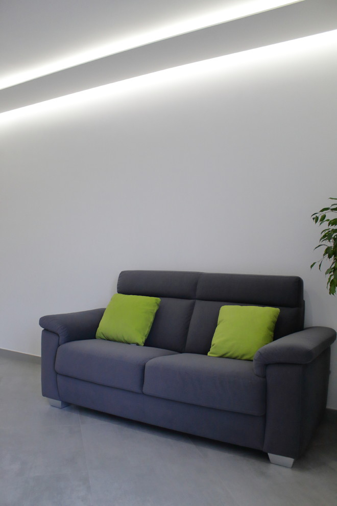 Inspiration för mellanstora moderna allrum med öppen planlösning, med vita väggar, klinkergolv i porslin, en inbyggd mediavägg och grått golv