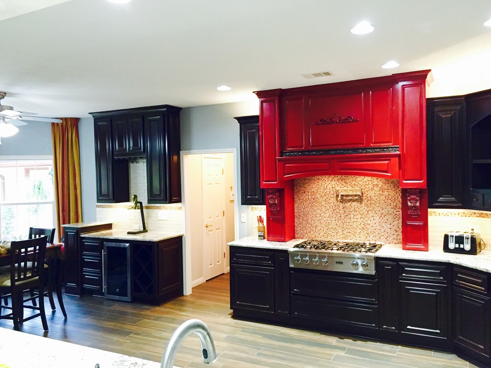 Example of a large transitional u-shaped dark wood floor and brown floor eat-in kitchen design in Austin with raised-panel cabinets, black cabinets, multicolored backsplash, mosaic tile backsplash and stainless steel appliances