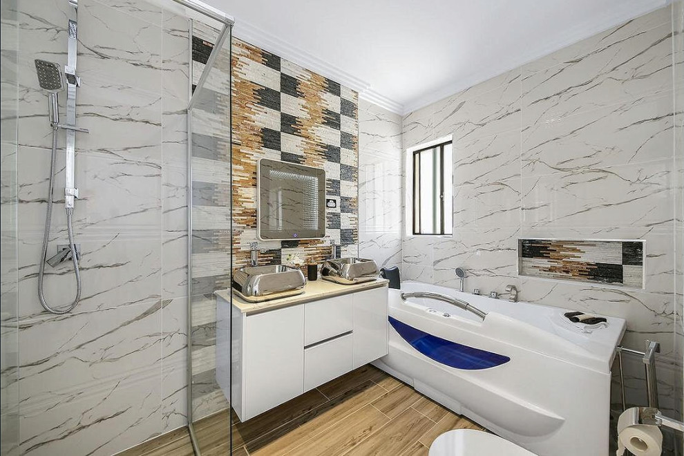 Inspiration for a mid-sized contemporary master bathroom in Sydney with flat-panel cabinets, white cabinets, a freestanding tub, a corner shower, beige tile, black tile, gray tile, a vessel sink, beige floor, a hinged shower door and beige benchtops.