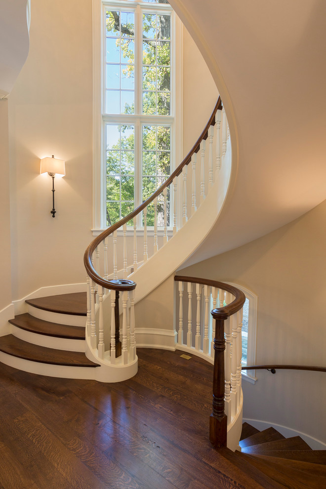 Design ideas for a mid-sized traditional wood spiral staircase in Chicago with painted wood risers.