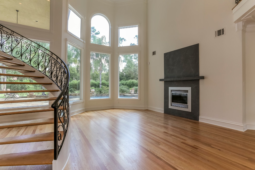 Large traditional foyer in Houston with white walls, light hardwood floors and beige floor.