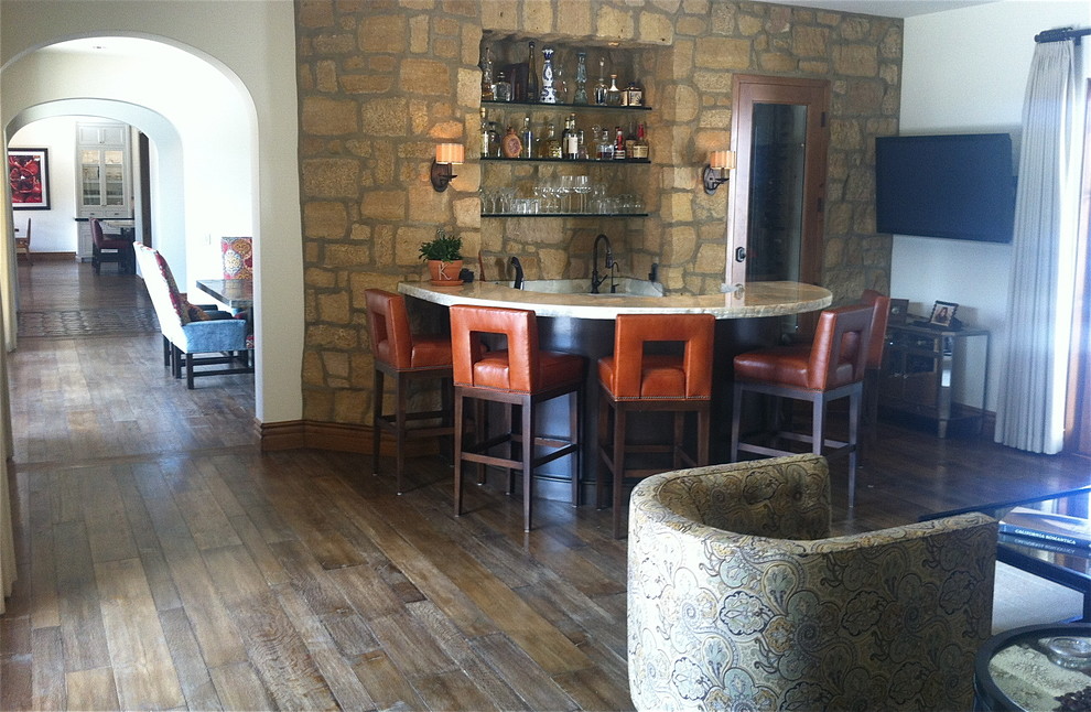 Mid-sized mediterranean seated home bar in Orange County with an undermount sink, brown splashback, medium hardwood floors and brown floor.
