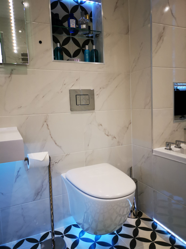 This is an example of a large contemporary master bathroom in West Midlands with a drop-in tub, a corner shower, white tile, porcelain tile, porcelain floors, engineered quartz benchtops, multi-coloured floor, a sliding shower screen, a niche, a single vanity and a floating vanity.