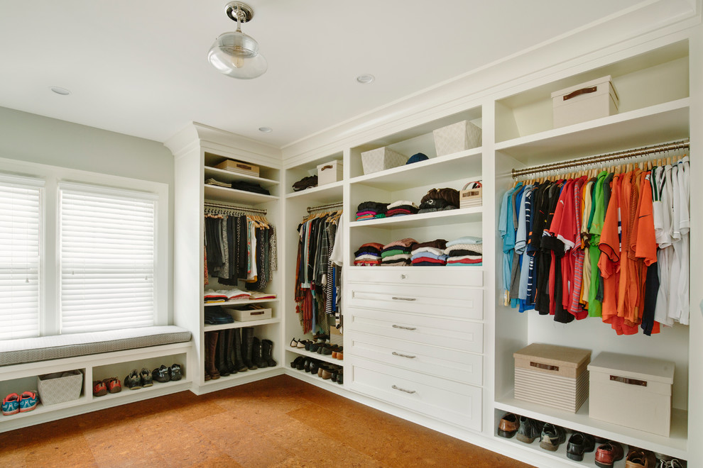 Inspiration for a mid-sized traditional gender-neutral walk-in wardrobe in Portland with recessed-panel cabinets, white cabinets and cork floors.