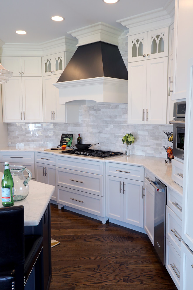 Inspiration for a large transitional u-shaped dark wood floor open concept kitchen remodel in Cincinnati with a single-bowl sink, flat-panel cabinets, white cabinets, granite countertops, gray backsplash, subway tile backsplash, paneled appliances and an island