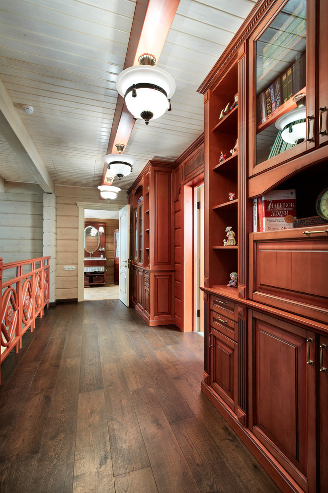 Photo of a mid-sized country hallway in Yekaterinburg with beige walls and dark hardwood floors.