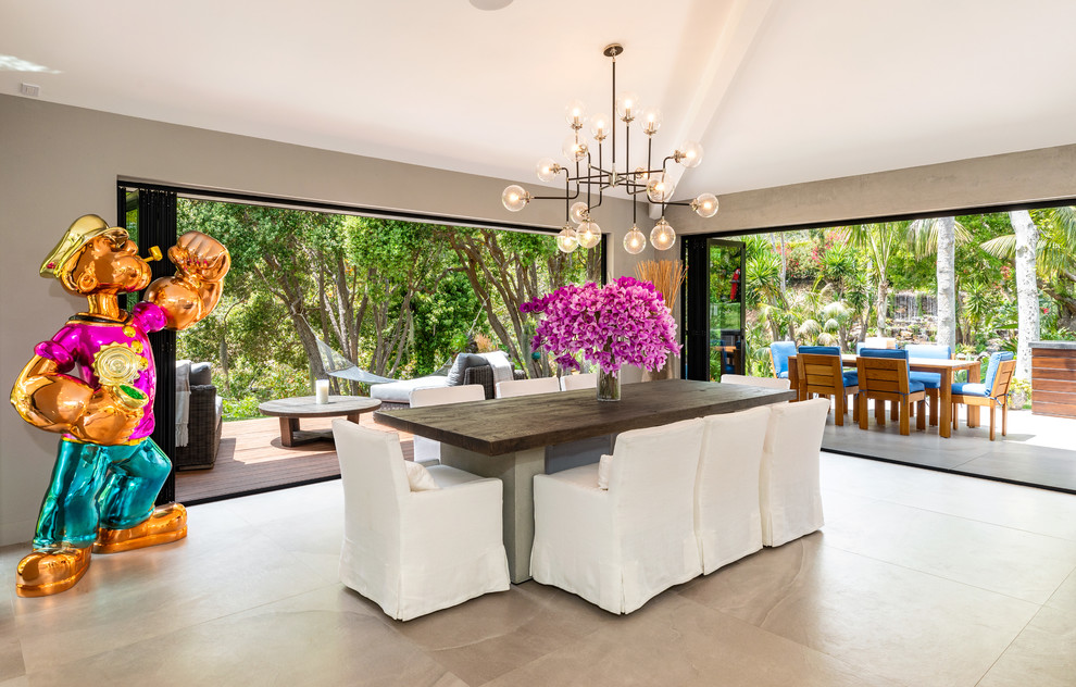 This is an example of a contemporary dining room in Los Angeles with brown walls and beige floor.