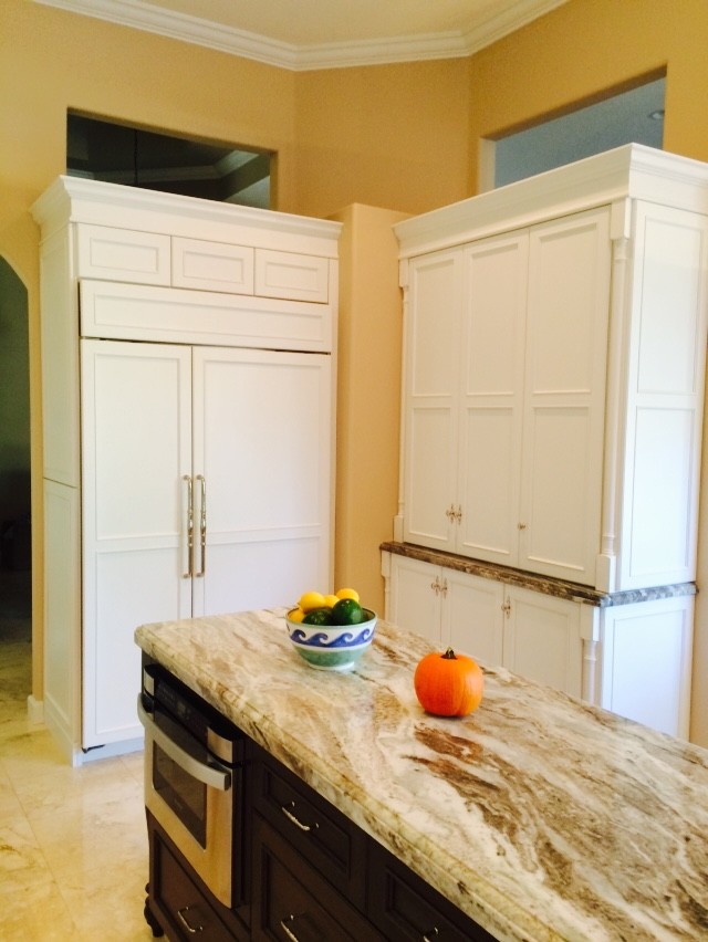 Photo of a mid-sized transitional kitchen pantry in Miami with flat-panel cabinets, white cabinets, quartzite benchtops, panelled appliances and marble floors.