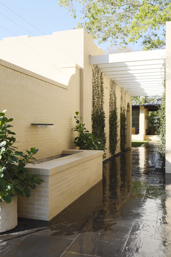 Design ideas for a contemporary garden in Tampa with a water feature.