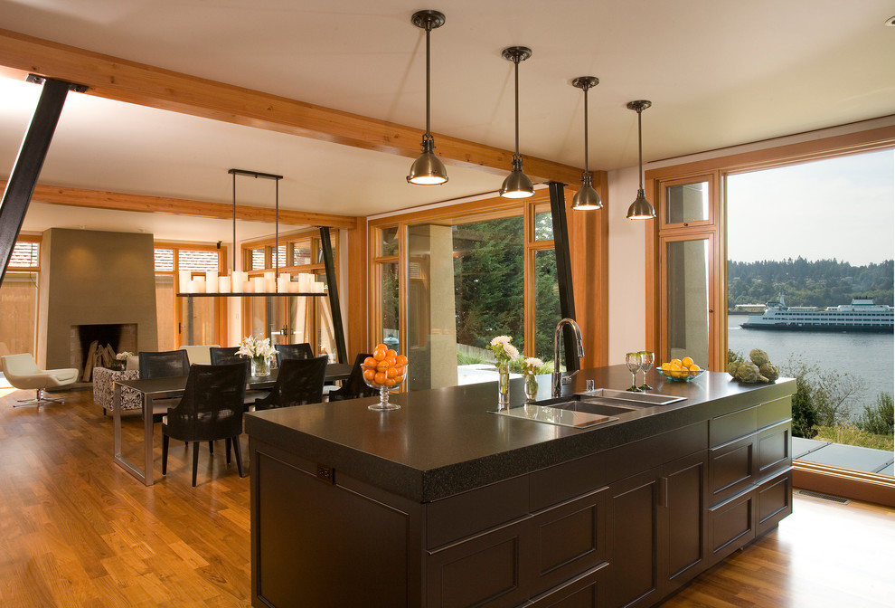 Design ideas for a contemporary open plan kitchen in Seattle with an undermount sink, recessed-panel cabinets, grey cabinets, quartz benchtops, medium hardwood floors and with island.