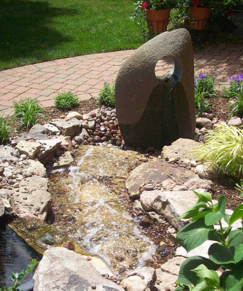 Photo of a traditional garden in Chicago with with pond.