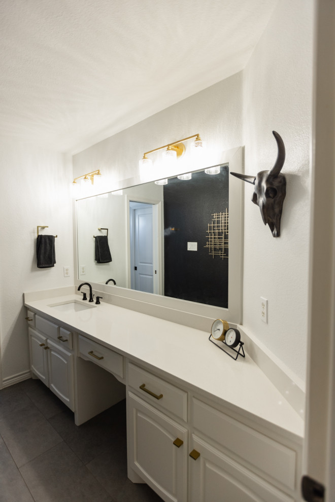 This is an example of a medium sized traditional family bathroom in Dallas with raised-panel cabinets, white cabinets, a built-in bath, a shower/bath combination, a one-piece toilet, white tiles, porcelain tiles, black walls, porcelain flooring, a submerged sink, engineered stone worktops, grey floors, a shower curtain, white worktops, a single sink and a built in vanity unit.