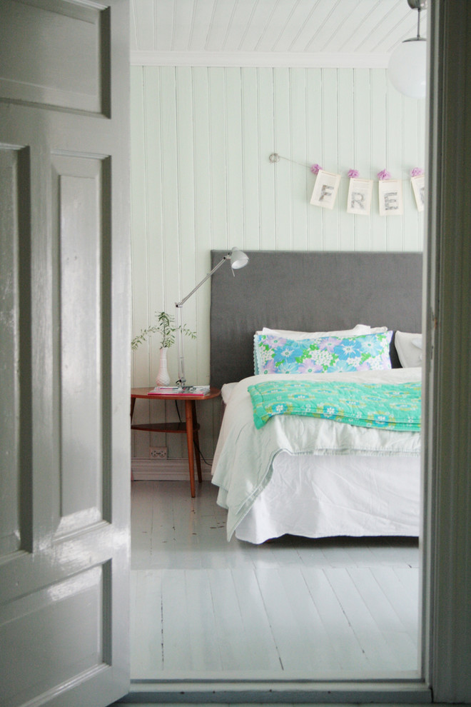 Eclectic bedroom in Other with green walls, painted wood floors and grey floor.