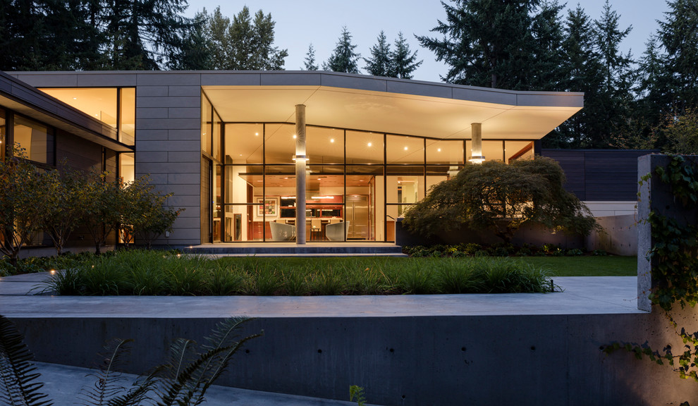Photo of a modern one-storey white exterior in Seattle with concrete fiberboard siding and a hip roof.