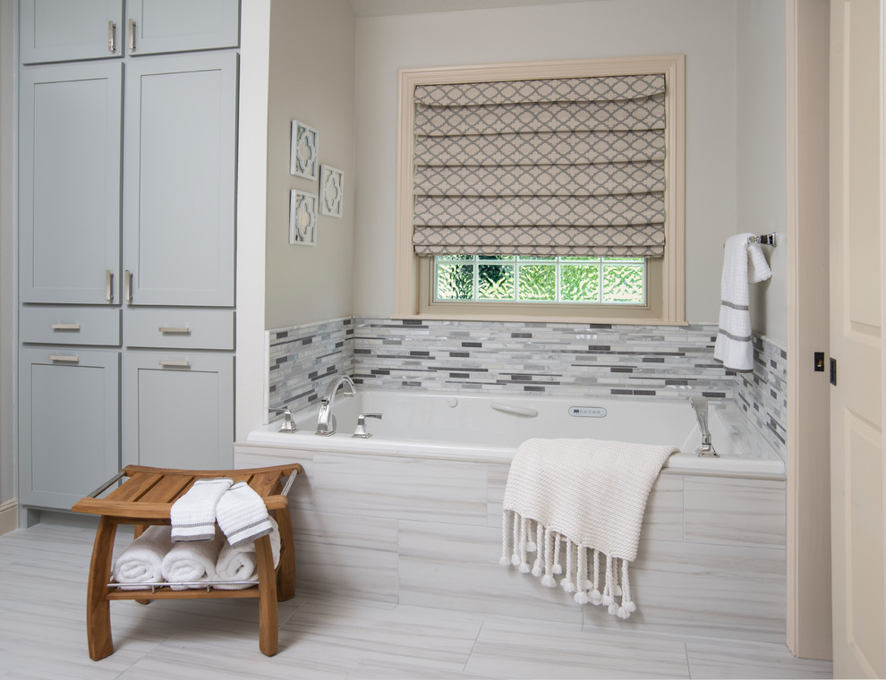 This is an example of a mid-sized contemporary master bathroom in Other with shaker cabinets, grey cabinets, an alcove tub, multi-coloured tile, matchstick tile, white walls, porcelain floors, an undermount sink, engineered quartz benchtops and grey floor.