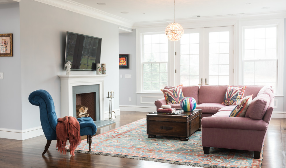 Inspiration for a traditional open concept family room in Boston with grey walls, dark hardwood floors, a standard fireplace, a wall-mounted tv and brown floor.