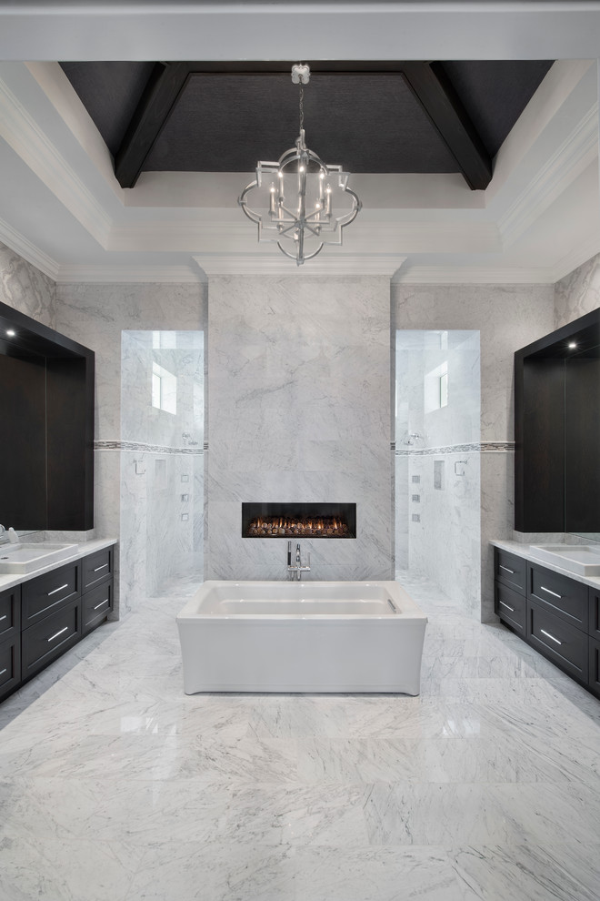 This is an example of an expansive transitional master bathroom in Miami with dark wood cabinets, granite benchtops, an open shower, gray tile and grey walls.