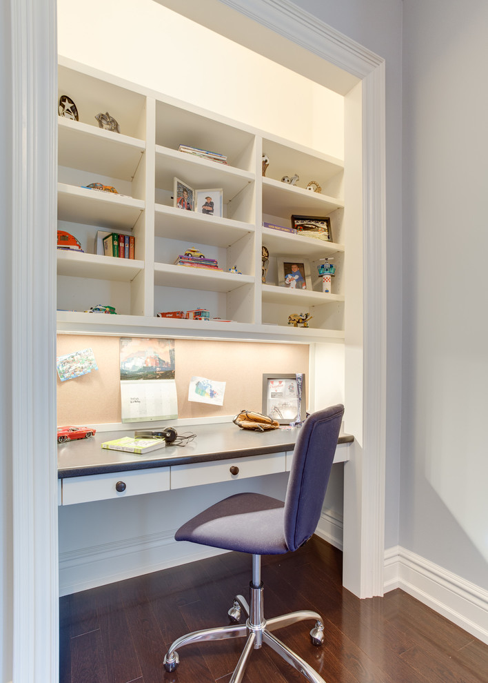 Example of a small transitional built-in desk dark wood floor home office design in Toronto with gray walls