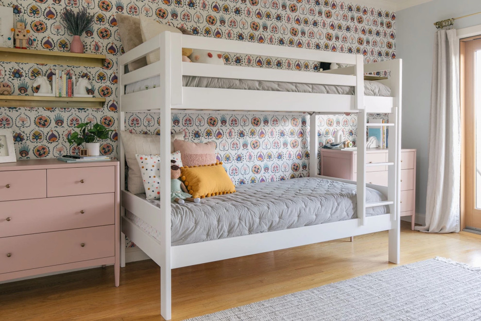 Design ideas for a contemporary kids' bedroom for kids 4-10 years old and girls in San Francisco with grey walls, medium hardwood floors, brown floor and wallpaper.