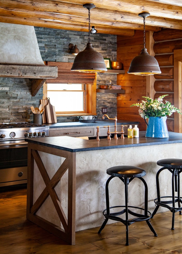 Large country l-shaped eat-in kitchen in Boston with a farmhouse sink, shaker cabinets, medium wood cabinets, soapstone benchtops, grey splashback, stone tile splashback, stainless steel appliances, medium hardwood floors, with island, brown floor and grey benchtop.