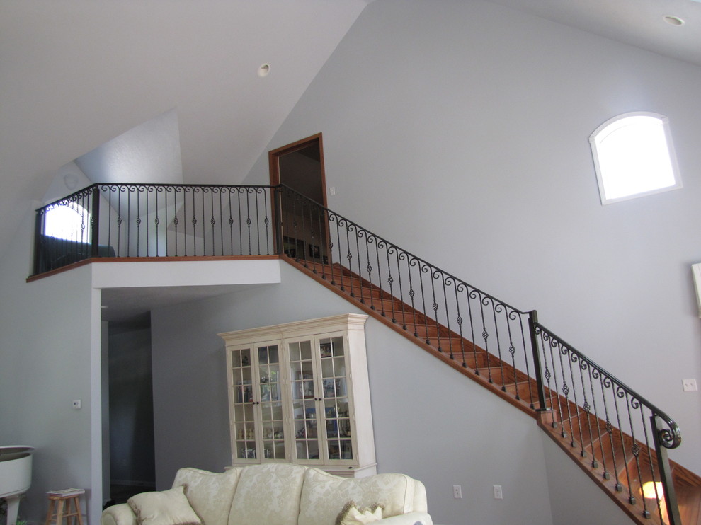 This is an example of a mid-sized traditional wood straight staircase in Orange County with wood risers.