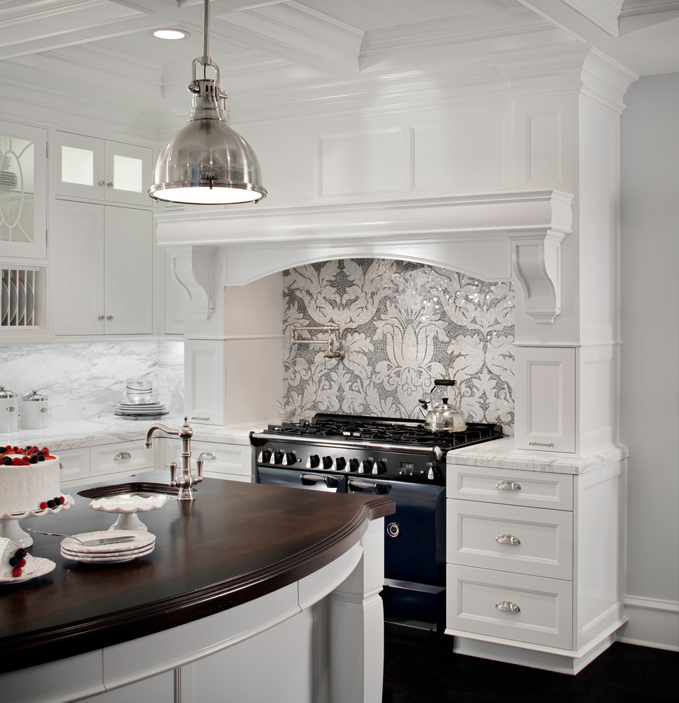 Inspiration for a large transitional u-shaped kitchen in Boston with an undermount sink, shaker cabinets, white cabinets, marble benchtops, grey splashback, marble splashback, black appliances, dark hardwood floors, with island and black floor.