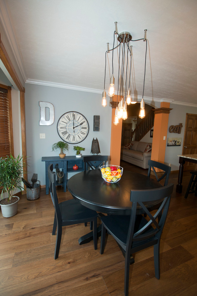 Inspiration for a large transitional l-shaped medium tone wood floor kitchen/dining room combo remodel with an undermount sink, shaker cabinets, white cabinets, granite countertops, gray backsplash, stone tile backsplash, stainless steel appliances and an island