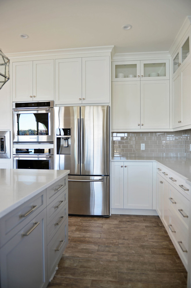 Example of a transitional kitchen design in Calgary