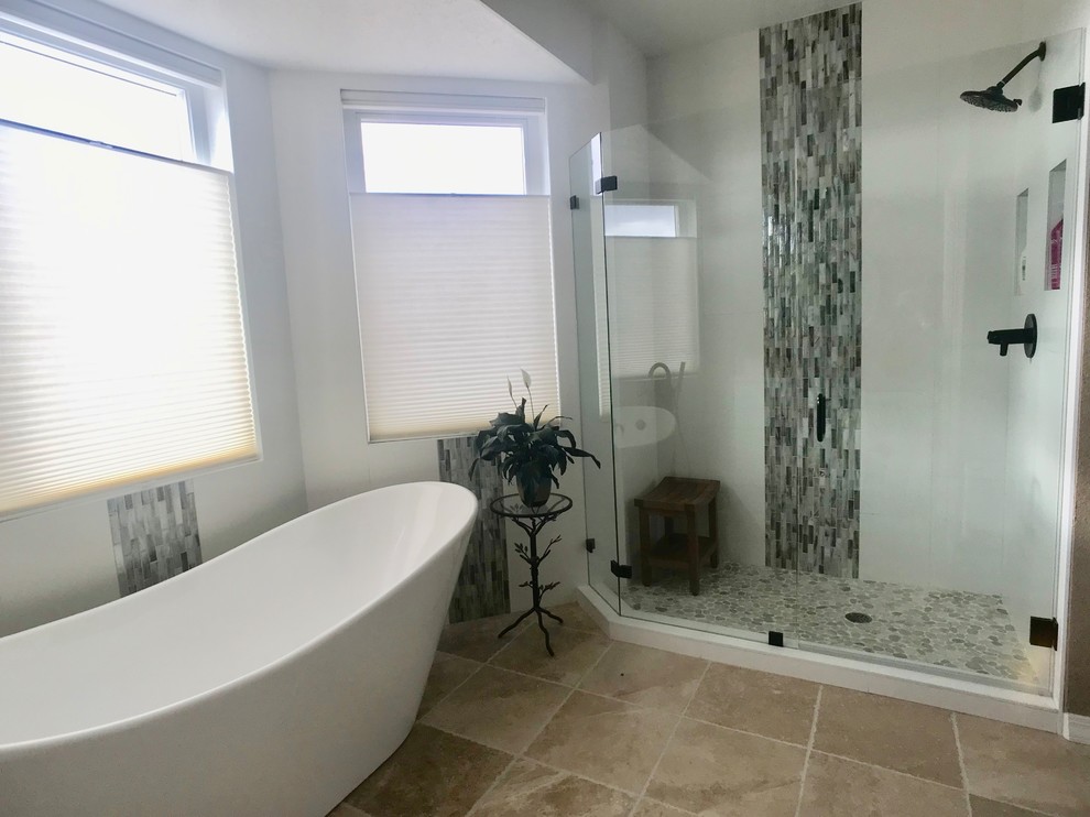 This is an example of a mid-sized transitional master bathroom in Albuquerque with a freestanding tub, a corner shower, mosaic tile, white walls, travertine floors, brown floor and a hinged shower door.