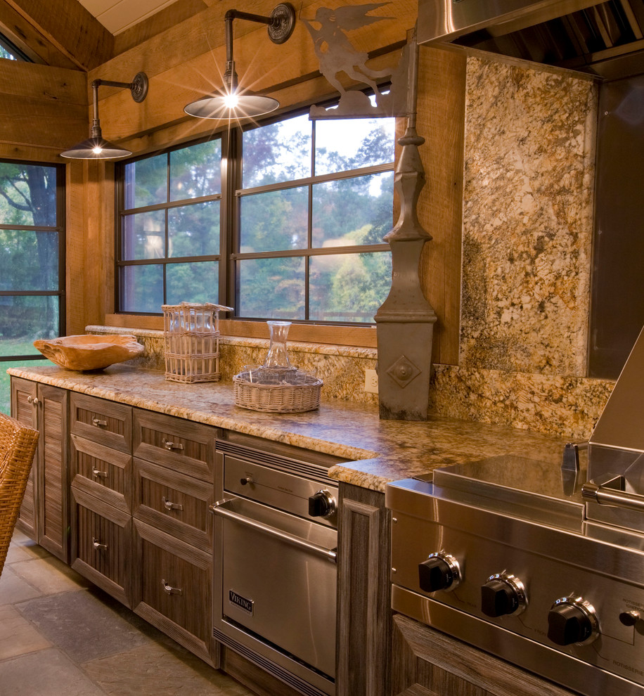 Example of a large mountain style l-shaped travertine floor and beige floor eat-in kitchen design in DC Metro with an undermount sink, shaker cabinets, dark wood cabinets, granite countertops, beige backsplash, stone slab backsplash, stainless steel appliances, an island and beige countertops