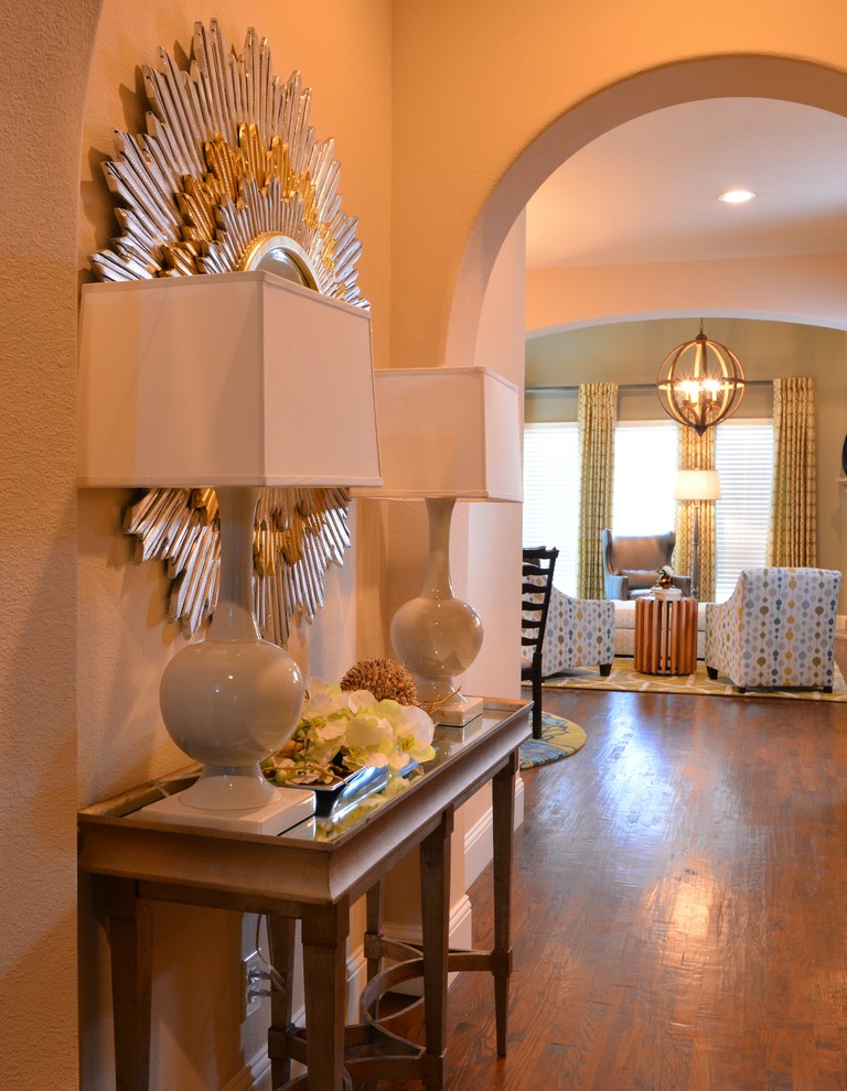Inspiration for a mid-sized transitional medium tone wood floor foyer remodel in Dallas with beige walls