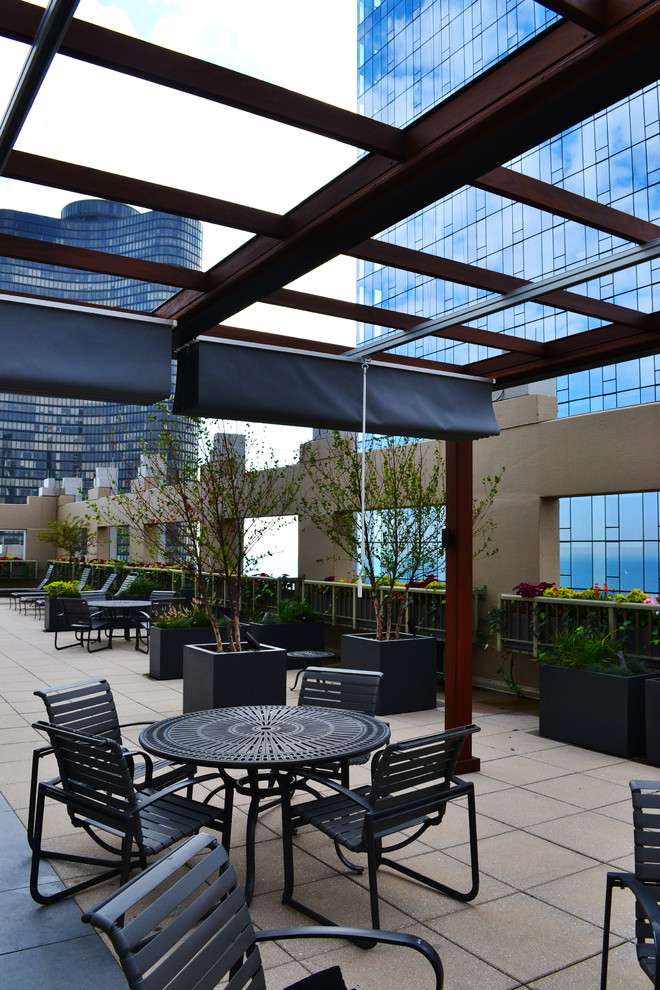 Photo of an expansive contemporary rooftop deck in Chicago with an outdoor kitchen and a pergola.