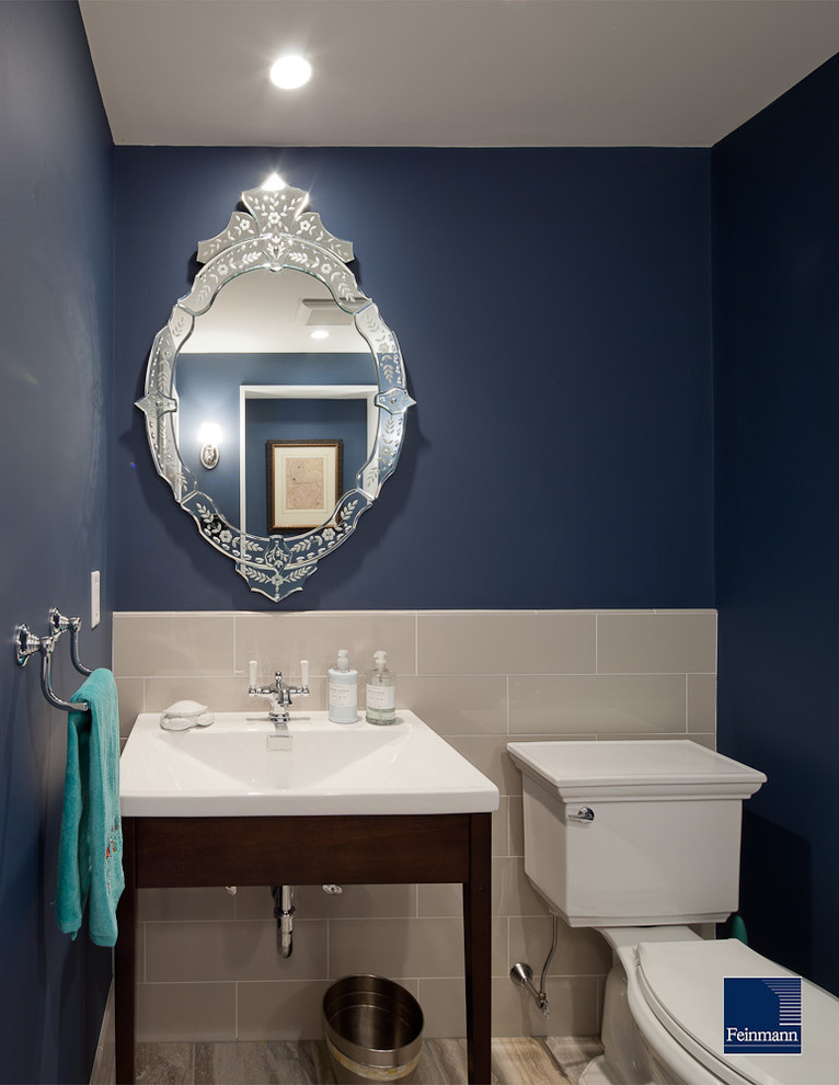 This is an example of a traditional powder room in Boston with a console sink.