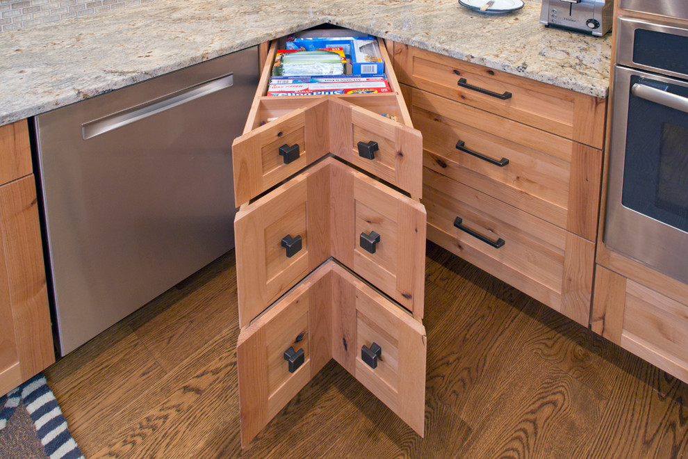 Example of a mid-sized transitional u-shaped medium tone wood floor eat-in kitchen design with shaker cabinets, stainless steel appliances, a peninsula, an undermount sink, medium tone wood cabinets, granite countertops, beige backsplash and matchstick tile backsplash