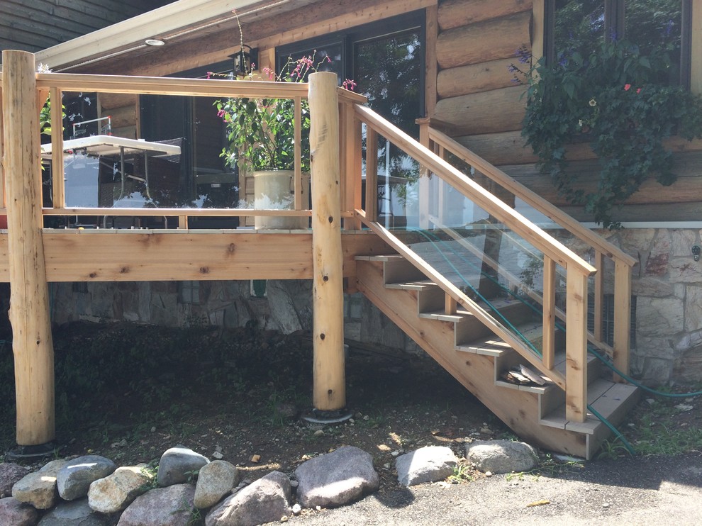 Mid-sized mountain style backyard deck photo in Milwaukee with no cover