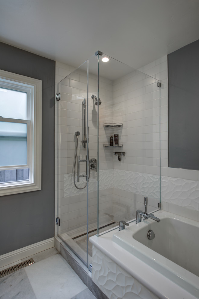 Photo of a mid-sized contemporary master bathroom in San Francisco with an undermount sink, flat-panel cabinets, white cabinets, engineered quartz benchtops, a corner shower, a one-piece toilet, white tile, porcelain tile, grey walls and marble floors.